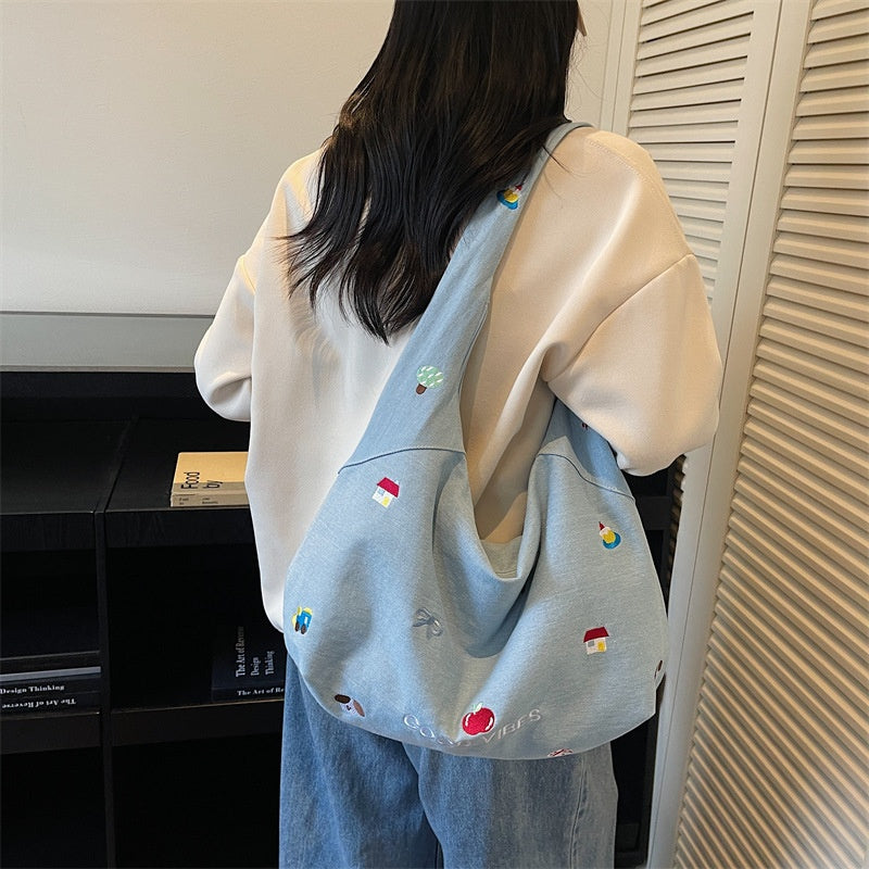 Meadow Denim Tote — worn or held by a model, supplier photograph