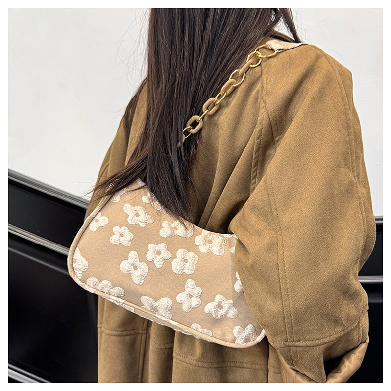 Petal Chain Shoulder Bag — worn or held by a model, supplier photograph