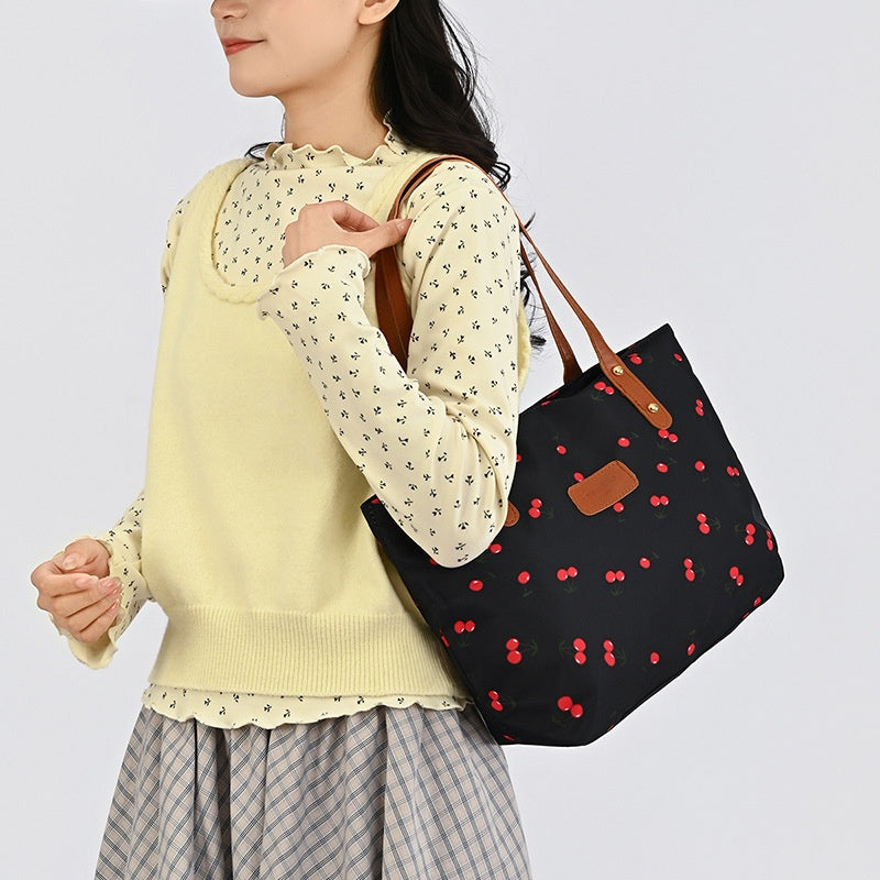 Cherry Day Shoulder Tote — worn or held by a model, supplier photograph