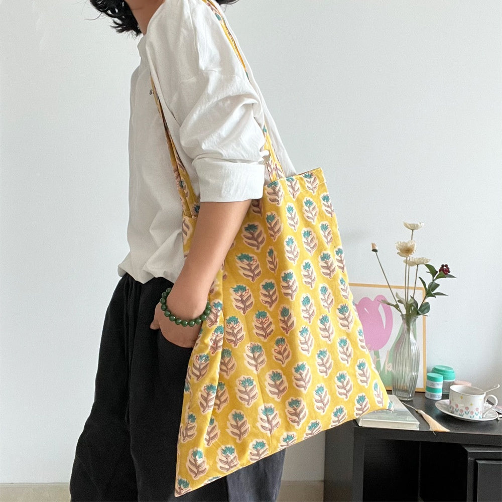 Golden Gardenia Tote — worn or held by a model, supplier photograph
