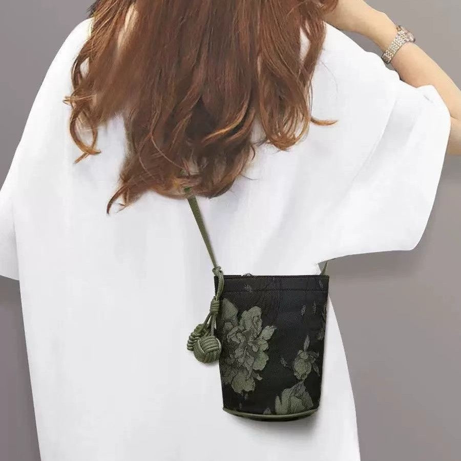 Petite Brocade Crossbody — worn or held by a model, supplier photograph